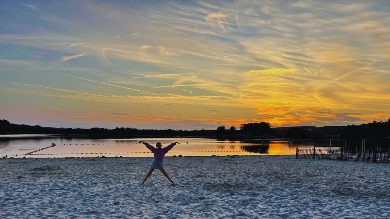 A star jump on the lake beach at sunset, Center Parcs Le Lac d’Ailette