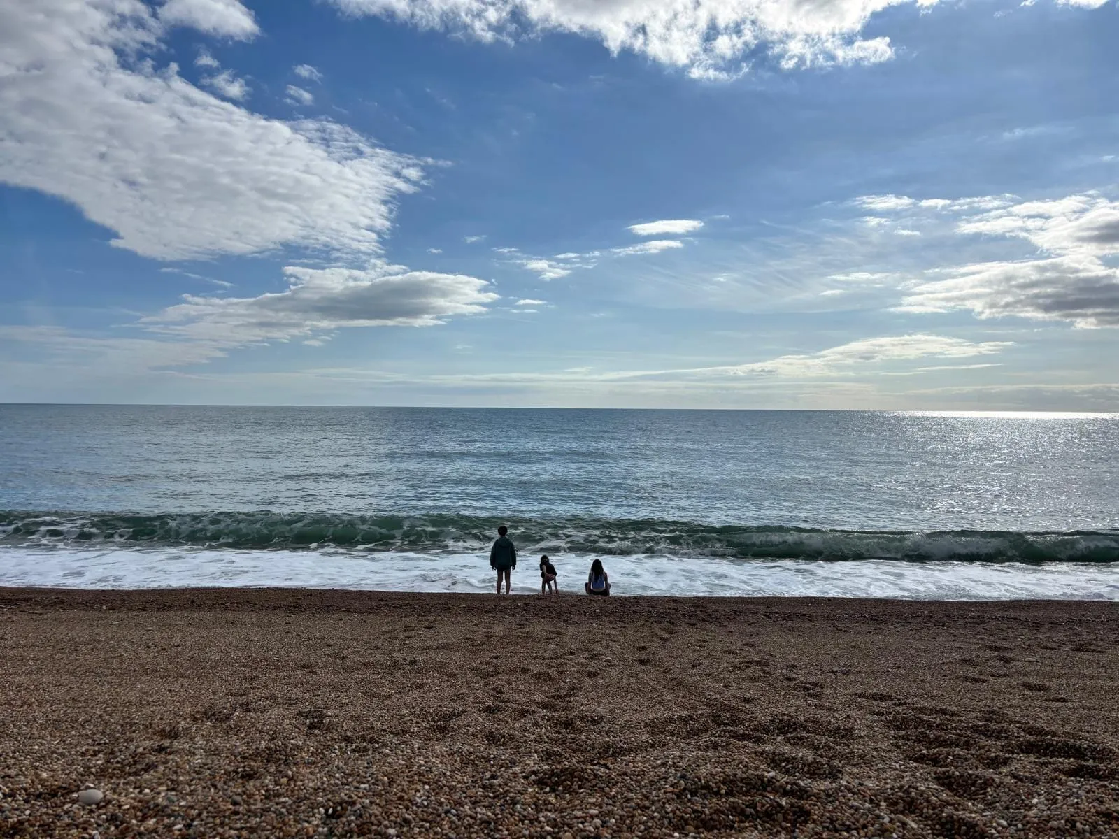 The kids by the waves on Chesil Beach